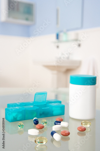 Photo: Pills and organiser in bathroom Pills and organiser in bathroom