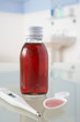 Thermometer and medicine on bathroom shelf
