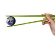 blue planet earth between green chopsticks