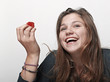 Young beautiful happy smiling woman with strawberry