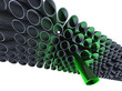 Lot of grey pipes with one high green Lot of grey pipes with one high green
