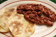 A plate of crispy tortillas and chorizo sausage A plate of crispy tortillas and chorizo sausage