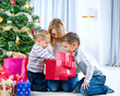 Children with Christmas gifts. Christmas tree