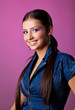 Cute young woman portrait in jeans on pink