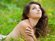 Woman lying naked in grass