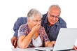Seniors couple using a computer laptop