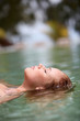 Woman floating in swimming pool