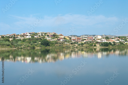 village of Mursi in Southern Albania, reflected in a man-made lake