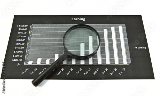 Photo: Magnifying glass over diagram. Magnifying glass over diagram.