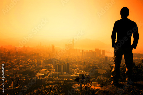 Photo: Man standing on the edge of Hong Kong's Lion Peak Man standing on the edge of Hong Kong's Lion Peak