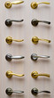 Set metal steel and golden handles on a light wooden wall