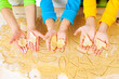 child's hands with dough over the table