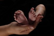 Newborn's Feet in Mother's Hand
