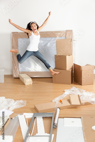 Photo: New home - moving woman excited New home - moving woman excited