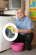 middle-aged man doing laundry