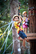 6 year old Kids climbing trees in Dolomites, Italy.