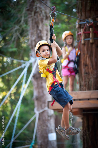 Photo: 6 year old Kids climbing trees in Dolomites, Italy. 6 year old Kids climbing trees in Dolomites, Italy.