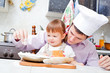 father with a small daughter do dough for pies