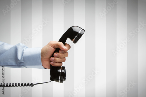 Фото: Human hand holding vintage telephone with copy space Human hand holding vintage telephone with copy space