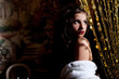 Cute young woman in dark cafe waiting for