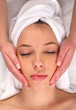 Beautiful woman receiving facial massage