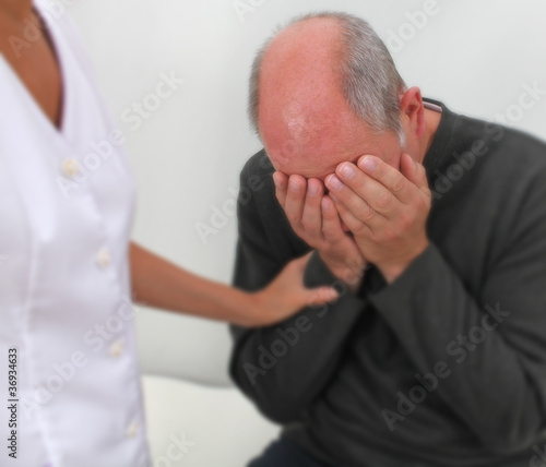 Photo: Therapist comforting distressed patient - soft blur Therapist comforting distressed patient - soft blur