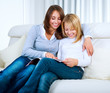 Mother with Teenage Daughter reading Magazine