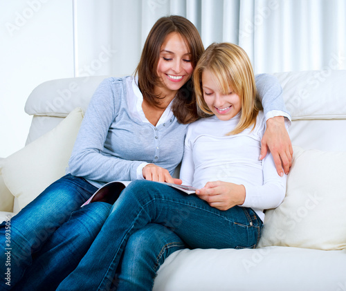 Photo: Mother with Teenage Daughter reading Magazine Mother with Teenage Daughter reading Magazine