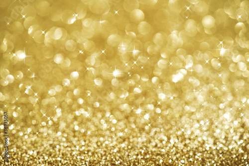 Photo: Christmas Glittering background. Holiday Gold abstract texture Christmas Glittering background. Holiday Gold abstract texture