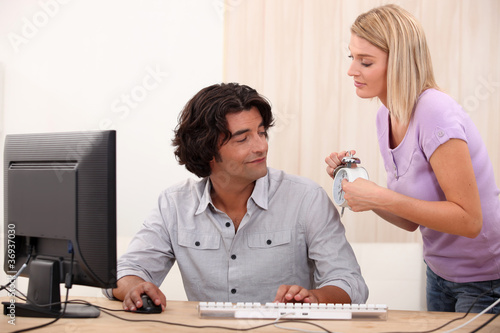 Photo: Woman reminding a man of the time Woman reminding a man of the time