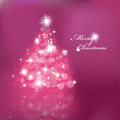 Christmas tree with blurred lights on purple background.