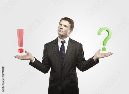 Foto: Businessman with a question and exclamation mark Businessman with a question and exclamation mark
