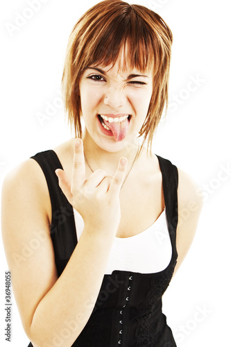 Photo: Portrait of cool brunette showing "rock on" gesture Portrait of cool brunette showing "rock on" gesture