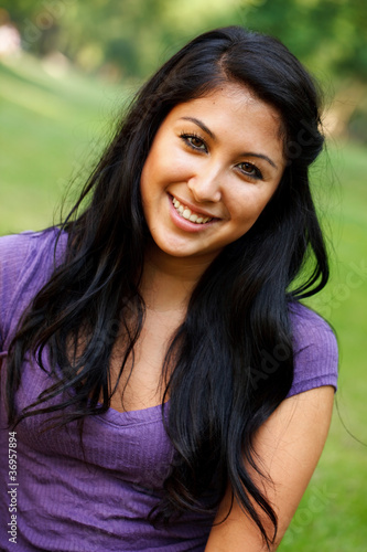 Photo: Portrait of young Asian Hispanic woman at the park Portrait of young Asian Hispanic woman at the park