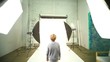 Boy walk across photo studio among spotlights