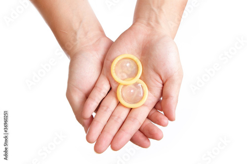 Photo: condom and hand isolated on white background condom and hand isolated on white background