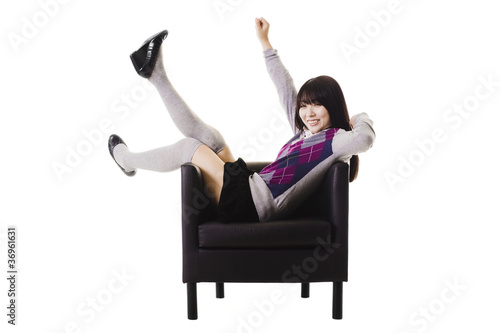 Photo: Excited Chinese student in a leather chair. Excited Chinese student in a leather chair.