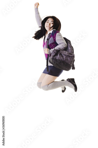 Photo: Chinese school girl jumping into air. Chinese school girl jumping into air.