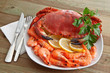 Crab with shrimp and parsley on a wooden table Crab with shrimp and parsley on a wooden table