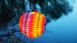 colorful bright paper ball hang on branch above lake colorful bright paper ball hang on branch above lake
