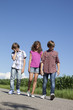 tired kids walking on a road