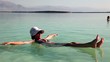 Woman lies on the surface of the Dead Sea. Woman lies on the surface of the Dead Sea.