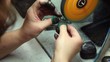 Video: Man polishes piece of jewelry with grinding wheel Man polishes piece of jewelry with grinding wheel