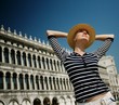 Beautiful woman in hat against Dodge's Palace