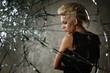 Punk girl behind broken glass