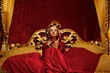 Beautiful woman with a carnival mask sitting in bed