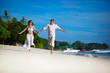 Young couple walking on the beach Young couple walking on the beach