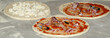 Pizza being baked in a wood fire brick oven in a restaurant