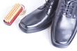 Classic black men's shoes, boot polish and brush