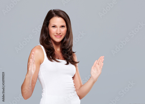 Photo: Young woman shows large size with hands Young woman shows large size with hands